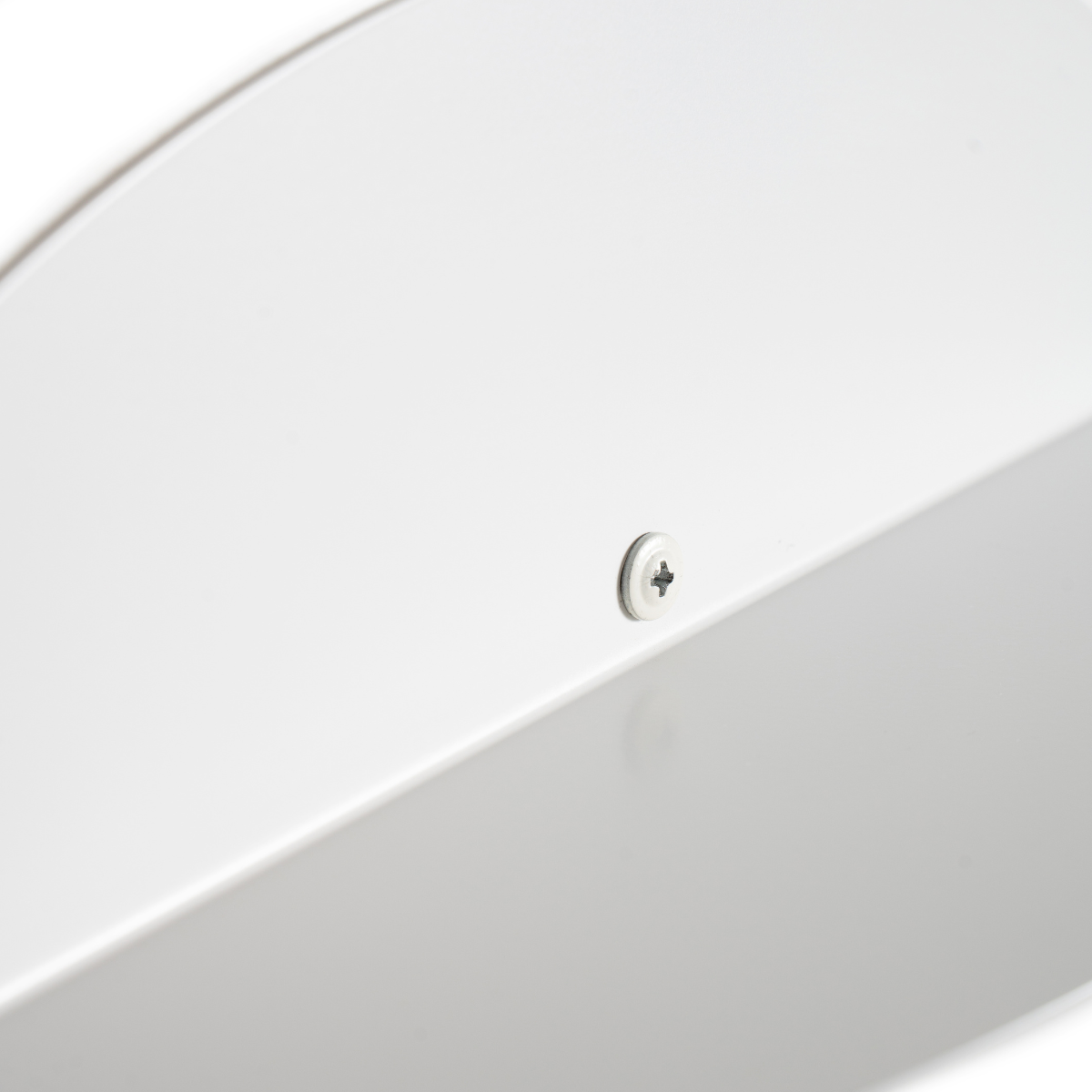 Close-up of a white elliptical metal floating shelf with a visible screw, highlighting the minimalist design and attention to detail.