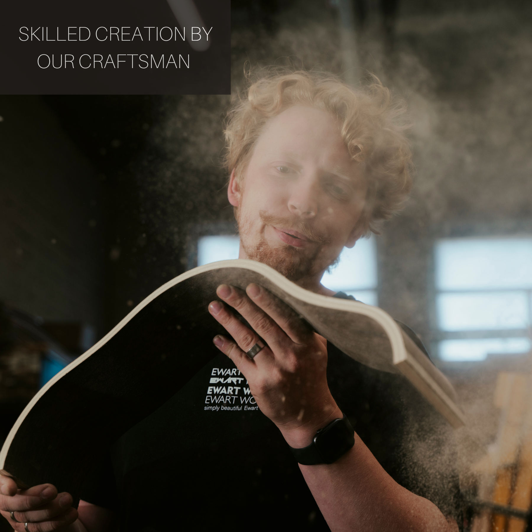 EWART WOODS craftsman holding wooden toilet paper holder in workshop