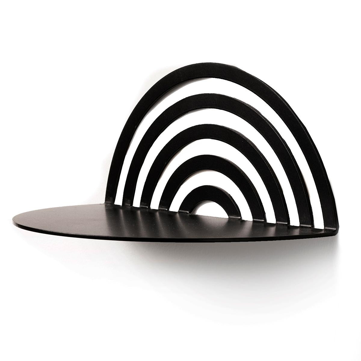 Matte black arch-shaped shelf with a layered, striped back, attached to the wall with screws, featuring a smooth, curved surface.