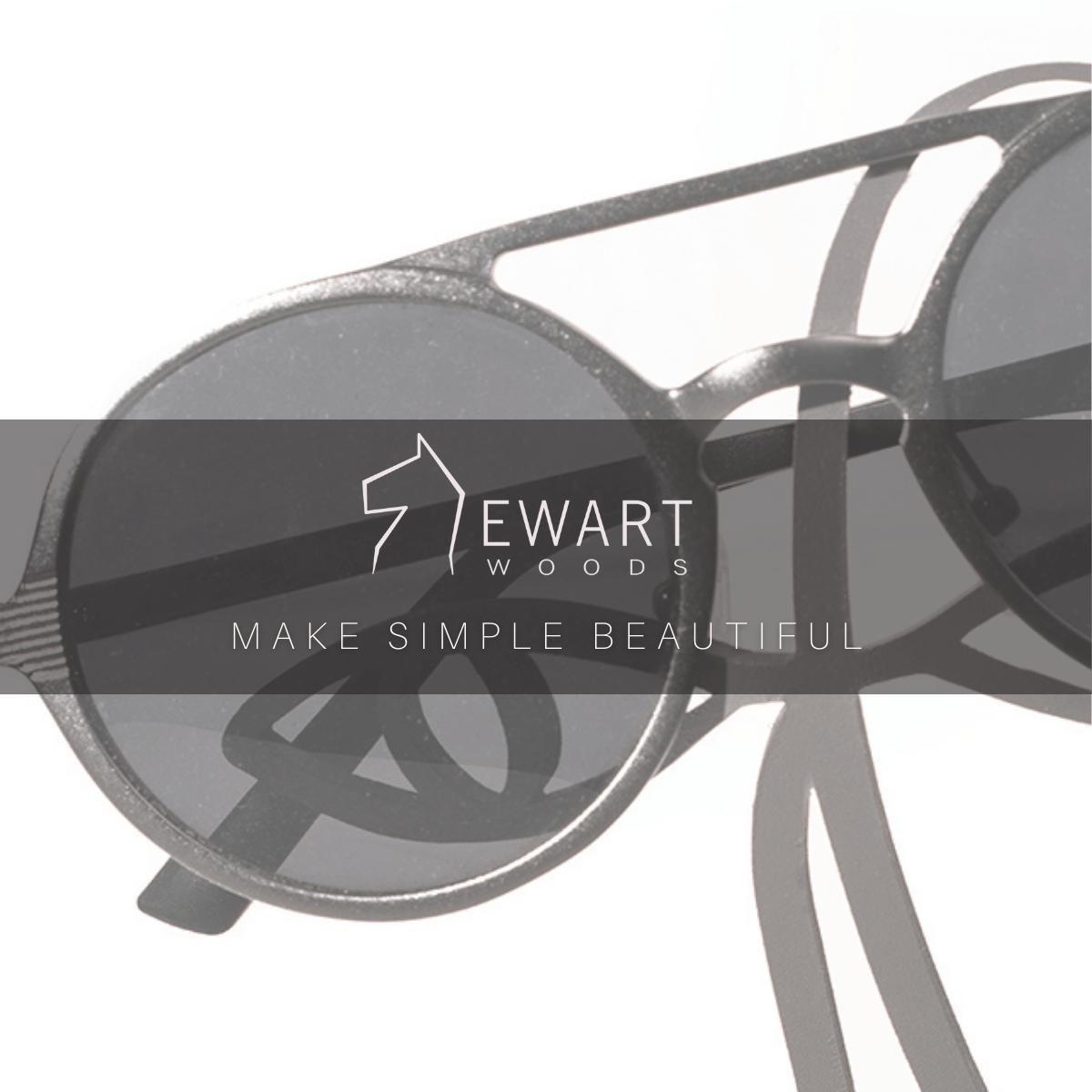 Close-up of a black metal abstract glasses holder with sunglasses placed over the eyes. The &