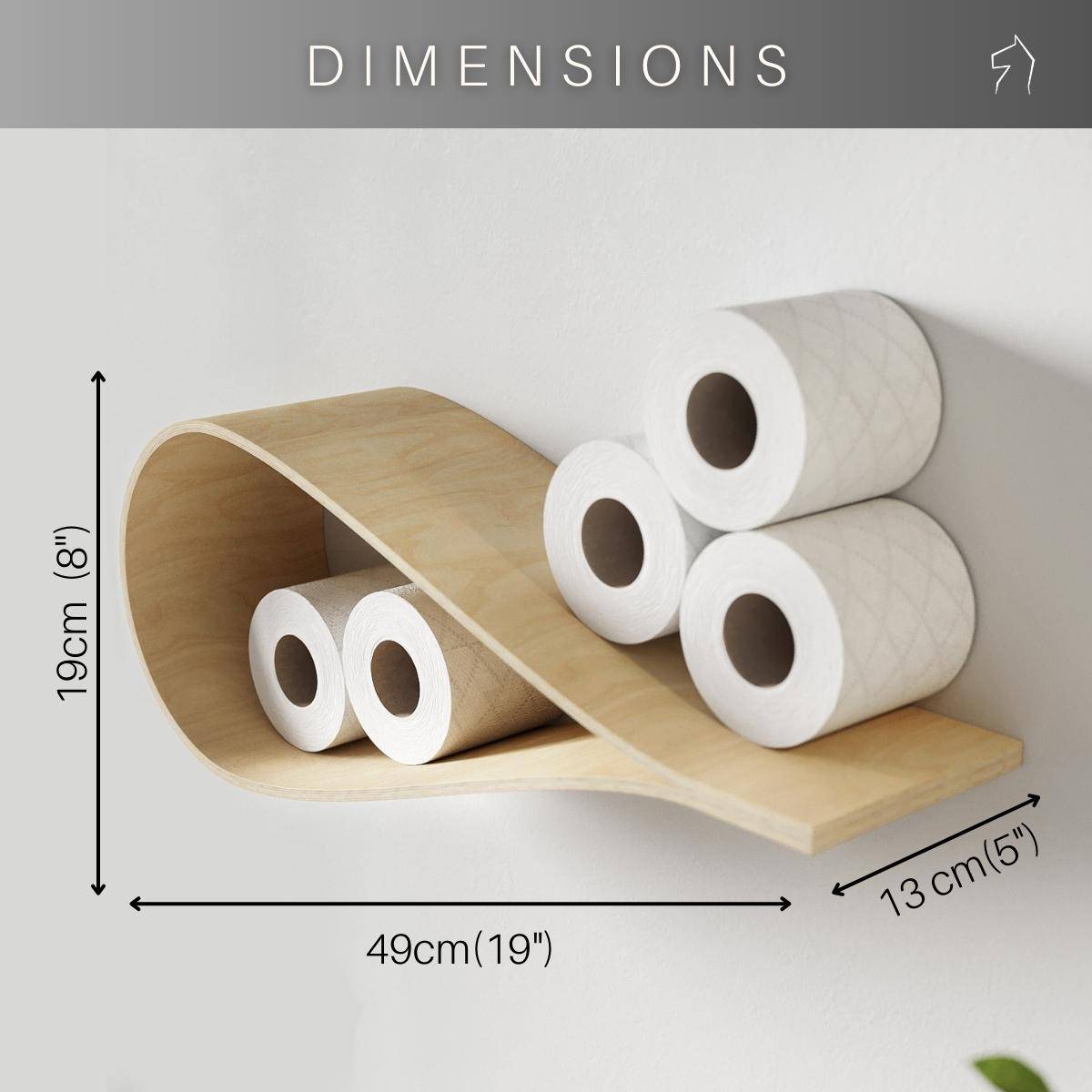 Drop-shaped birch wall shelf holding toilet paper rolls, displayed with text indicating it’s made in Europe, fits 11.5 cm (4.5”) rolls, and is easy to set up. The bathroom features minimalist design with natural wood and modern fixtures.