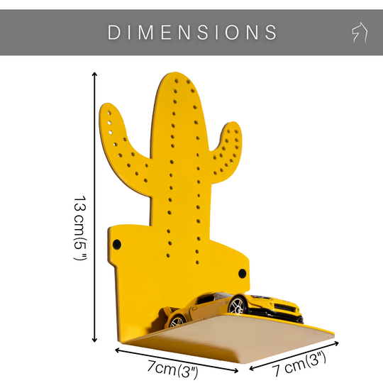Yellow metal cactus-shaped hook with perforated details, featuring dimensions of 13 cm (5 inches) in height and 7 cm (3 inches) in width and depth, mounted on a white background with a small toy car on the shelf