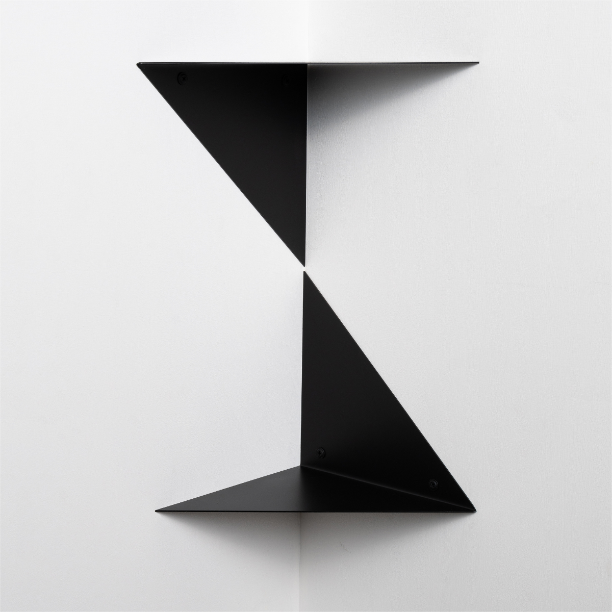 two metal corner room shelves black triangular forms attached one on top of the other white background