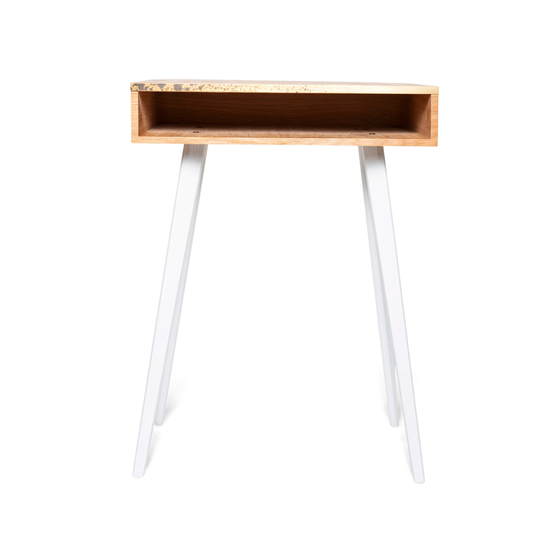 Front view of rectangular wooden nightstand with brass design and white wooden legs 