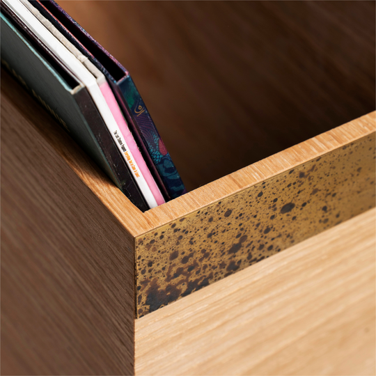 Close-up of brass plate detail on wooden vinyl record storage 