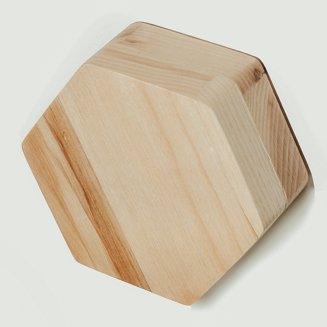 Hexagonal wooden key holder with a natural wood grain pattern, featuring a minimalist style and durable wood material.