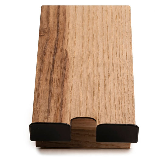 Top view of a phone stand with a wooden surface, featuring black metal supports for holding a phone and an integrated charging slot.