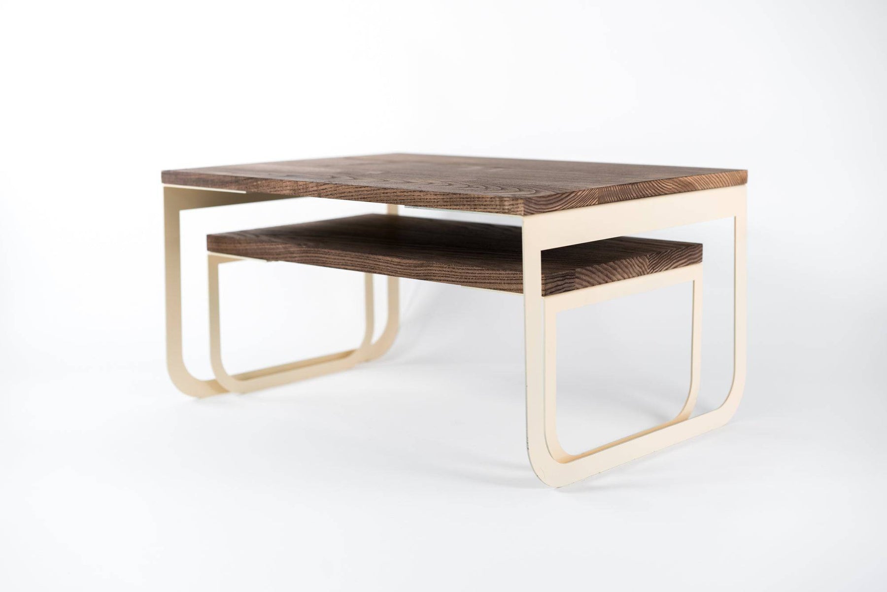 Modern wooden tray set featuring warm wood surfaces and sleek ivory metal legs, designed for versatile use in small spaces.
