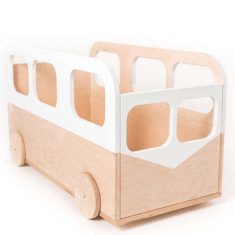 A wooden toy bus with a minimalist design, featuring round wheels and white cutout windows on its sides. The bus has an open top and smooth edges, suitable for children's play or storage.